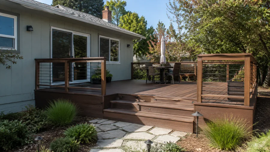 Renovated deck with new surface, cable railings and lit steps