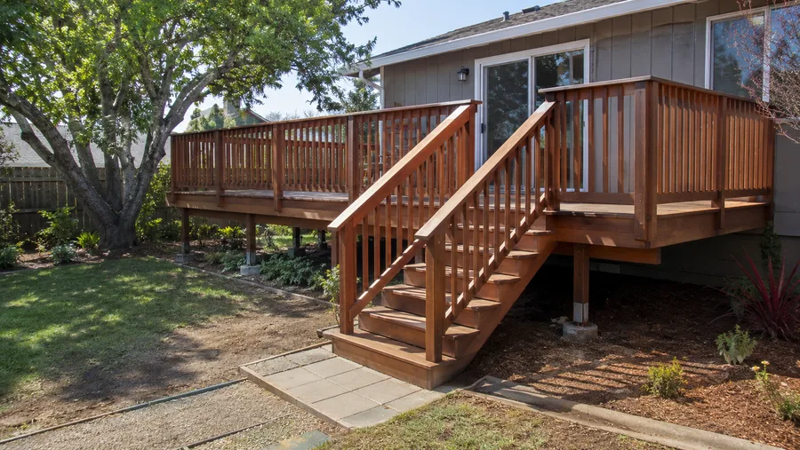 Completed replacement deck with new railings, stairs and refinished timber