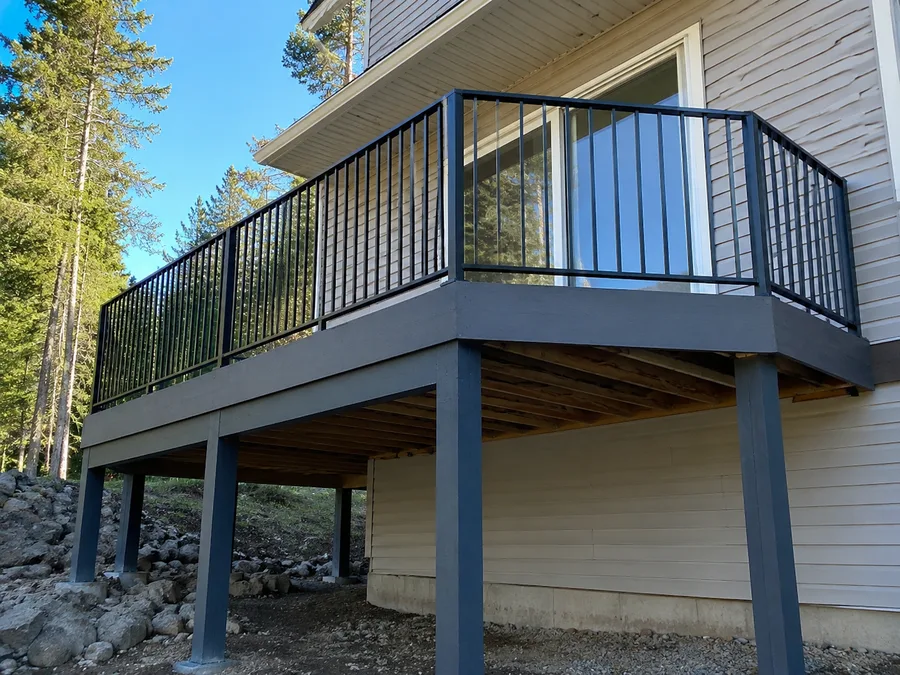 High balcony on a sloping site, supported on tall posts stepping down the grade