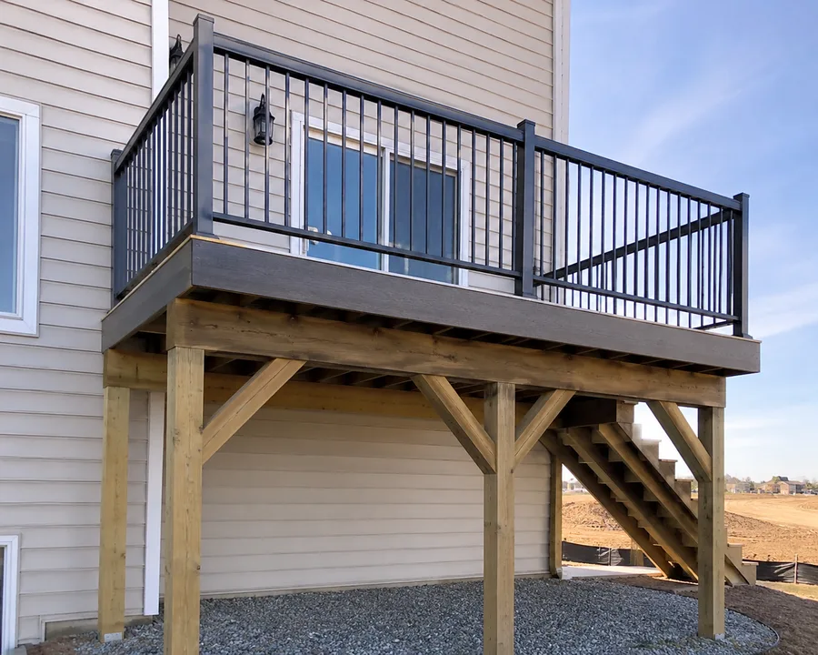 Raised balcony on braced timber posts with composite decking and metal guardrails