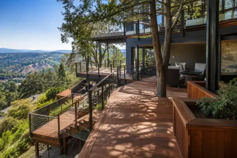 Multi-level deck stepping down a wooded hillside, connected by a staircase between levels