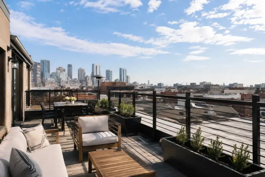 Rooftop balcony deck beside the exposed flat roof surface it was built over