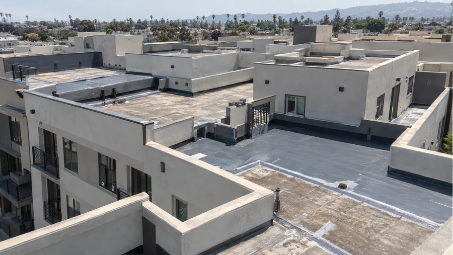 Multifamily rooftops with membrane surfaces and parapet upstands across a whole community