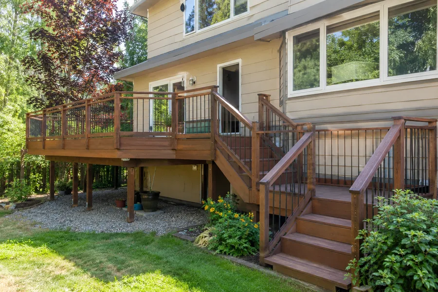 Elevated thermally modified deck with timber railings, metal balusters and a stair run