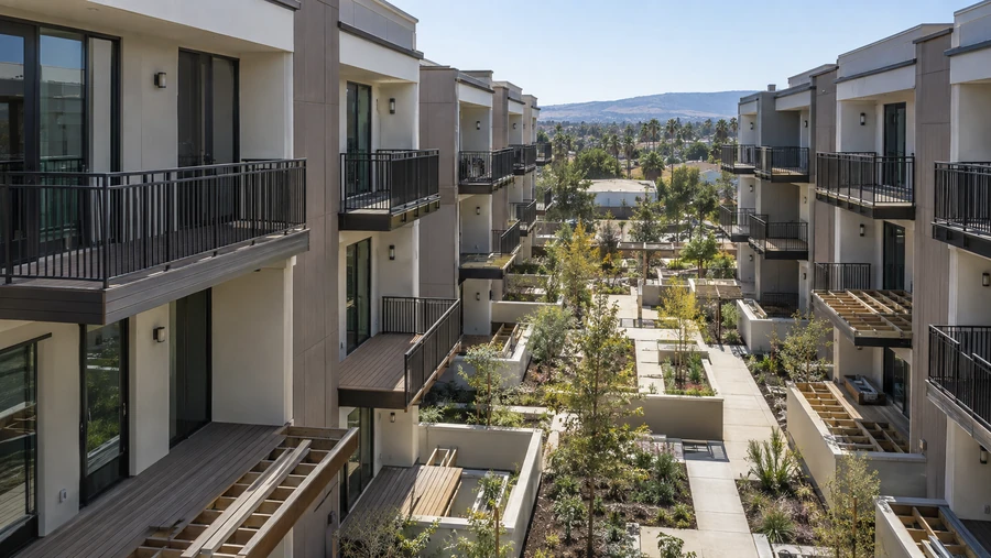 Courtyard view of composite decks at various stages of installation across two buildings