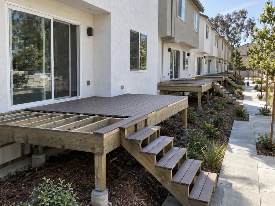 Deck with composite surface laid to the door and the remaining joists exposed