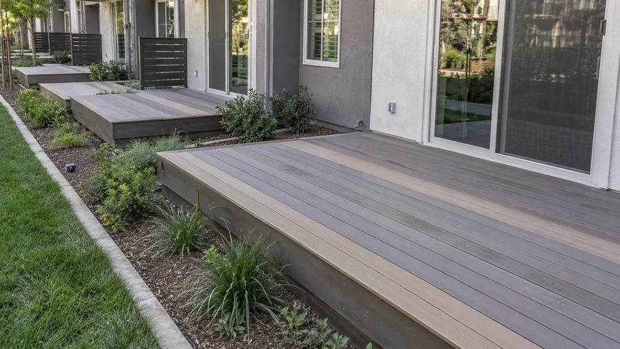Finished composite platform deck with lighter accent stripes, matching decks along a row of sliding doors