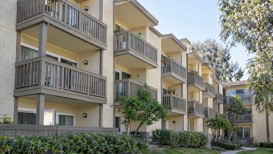 Apartment elevation with under-deck ceilings across every balcony, keeping the space below dry
