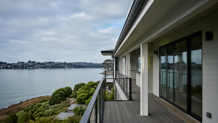 Long waterfront balcony with cable guardrails overlooking the shoreline