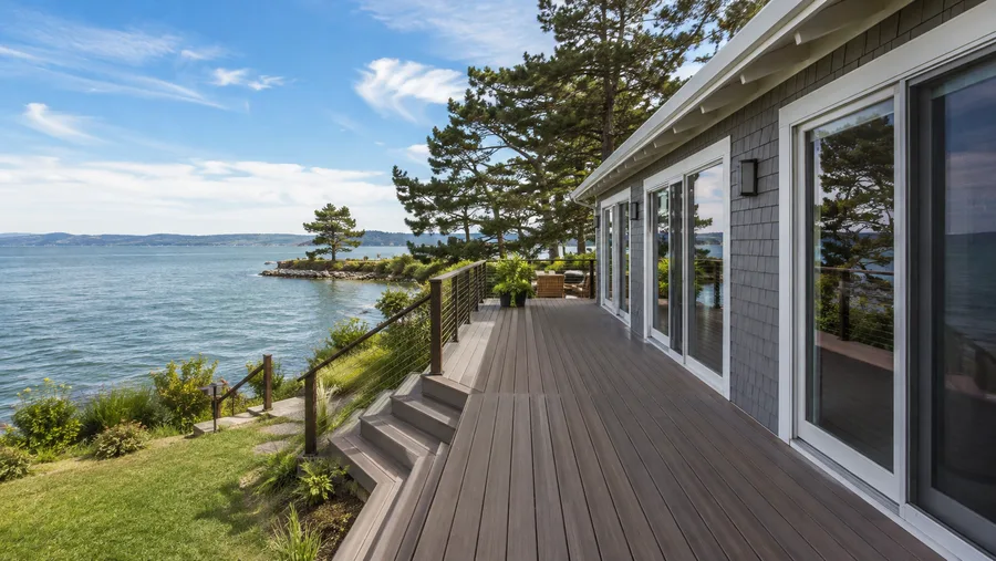 Waterfront deck with cable guardrails and steps, open to the water beyond
