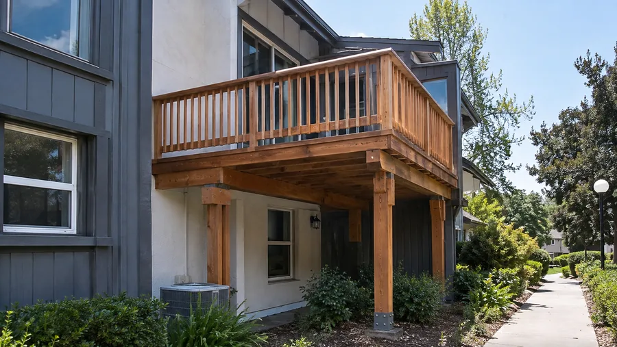 Cedar balcony on timber posts with metal post bases set on concrete piers