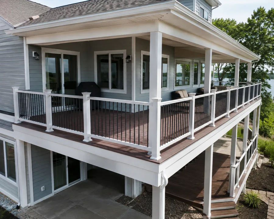 Wraparound balcony with composite decking and guardrails continuing around the corner