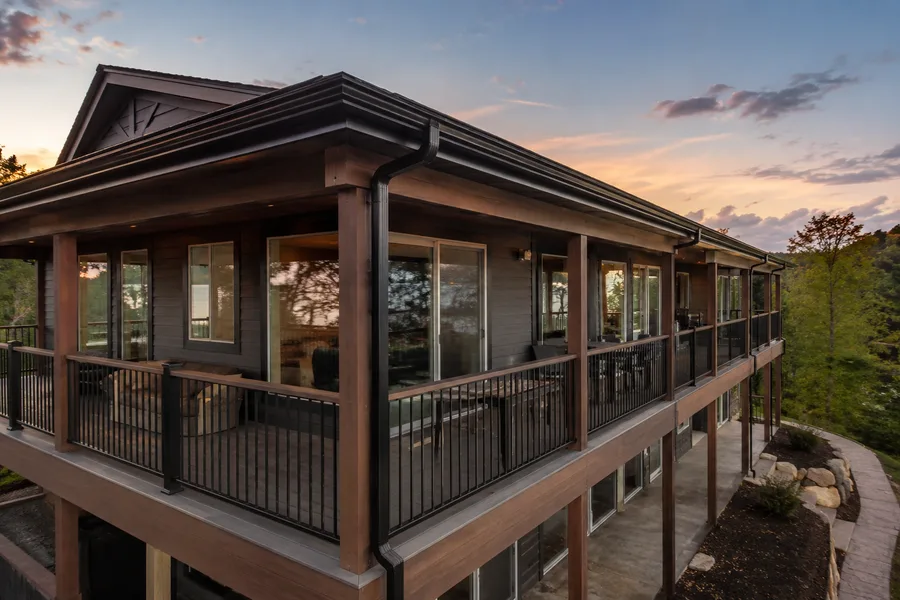 Wraparound balcony with a downspout at the corner and guardrails on both legs
